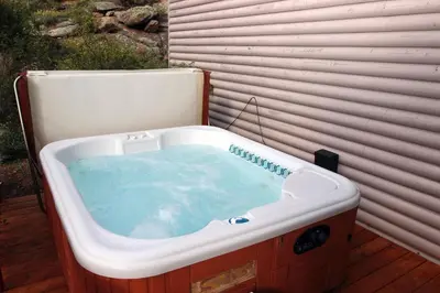 a jacuzzi tub sitting on a deck at Sunnyside Knoll- 16 cabin in Estes Park