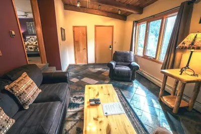 a living room with a couch and a coffee table at Sunnyside Knoll- 15 cabin in Estes Park