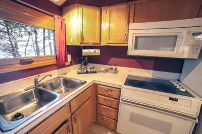 a kitchen with a sink and a microwave at Sunnyside Knoll- 15 cabin in Estes Park