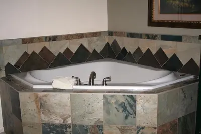 a bath tub with a towel sitting on top of it at Fawn Valley Inn- 102 condo in Estes Park