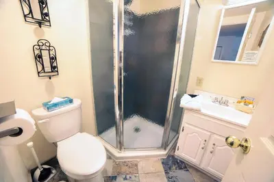 a bathroom with a shower and a toilet and a sink at Fawn Valley Inn- 102 condo in Estes Park