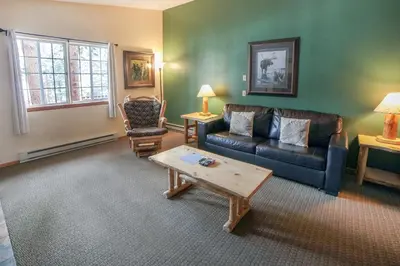 a living room with a couch and a coffee table at Timber Creek Chalets- 12 chalet in Estes Park