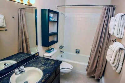 a bathroom with a sink and a toilet and a tub at Fawn Valley Inn- 282 condo in Estes Park