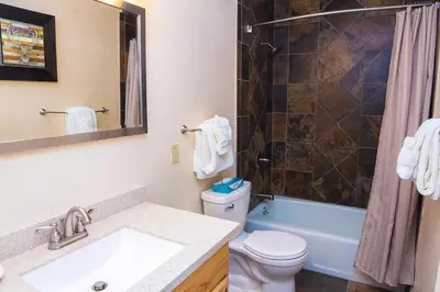 a bathroom with a sink and a toilet and a shower at Fawn Valley Inn- 303 apts in Estes Park