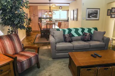 a living room with a couch and a table at Fawn Valley Inn- 240 condo in Estes Park