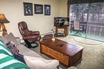 a living room with a couch and a coffee table at Fawn Valley Inn- 240 condo in Estes Park