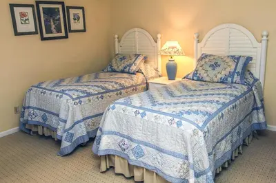 a bedroom with two beds and a lamp on a table at Fawn Valley Inn- 240 condo in Estes Park