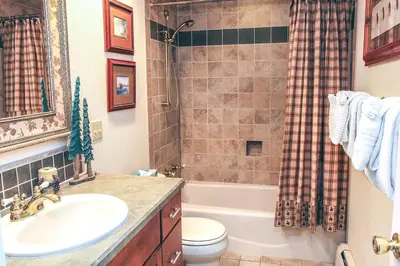 a bathroom with a sink and a toilet and a shower at Fawn Valley Inn- 240 condo in Estes Park