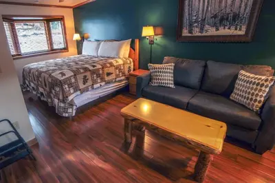 a living room with a couch and a bed at Sunnyside Knoll- 2 cottage in Estes Park