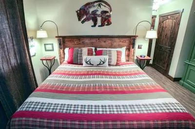 a bedroom with a large bed with pillows at Fawn Valley Inn- 269 condo in Estes Park