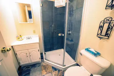 a bathroom with a shower and a toilet and a sink at Fawn Valley Inn- 105 condo in Estes Park