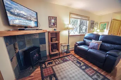 a living room with a couch and a fireplace at Fawn Valley Inn- 235 condo in Estes Park