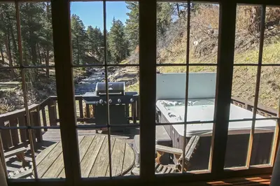 a view from a window of a deck with a boat at Fawn Valley Inn- 157 cabin in Estes Park