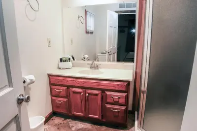 a bathroom with a sink and a mirror at Fawn Valley Inn- 157 cabin in Estes Park