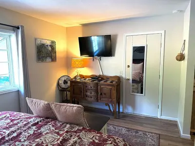 a bedroom with a bed and a television on the wall at Fawn Valley Inn- 288 condo in Estes Park
