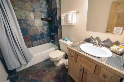 a bathroom with a sink and a toilet and a shower at Fawn Valley Inn- 279 condo in Estes Park