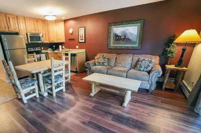 a living room with a couch and a table at Fawn Valley Inn- 298 condo in Estes Park