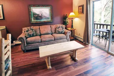 a living room with a couch and a coffee table at Fawn Valley Inn- 298 condo in Estes Park