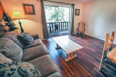 a living room with a couch and a coffee table at Fawn Valley Inn- 298 condo in Estes Park