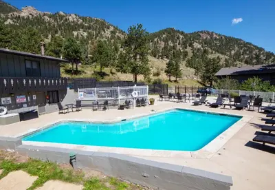 a swimming pool in front of a mountain at Fawn Valley Inn- 298 condo in Estes Park