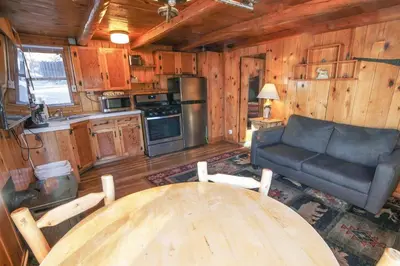a living room with a table and a couch at Lazy R Cottages- 3 cabin in Estes Park
