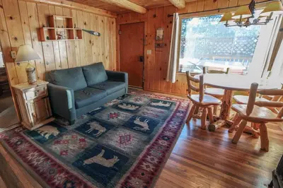 a living room with a couch and a table at Lazy R Cottages- 3 cabin in Estes Park