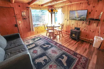 a living room with a couch and a table at Lazy R Cottages- 3 cabin in Estes Park