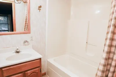 a bathroom with a sink and a bath tub at Lazy R Cottages- 3 cabin in Estes Park