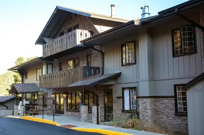 a large brick building with a balcony on a street at Fawn Valley Inn- 290 condo in Estes Park