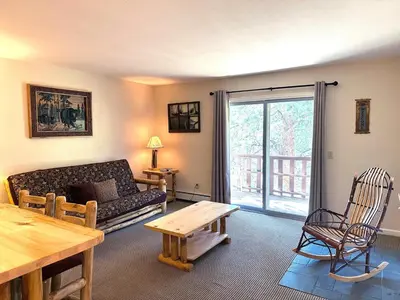 a living room with a couch and a table at Fawn Valley Inn- 290 condo in Estes Park