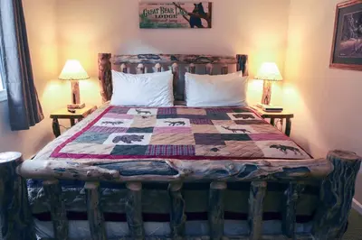 a bedroom with a bed with a quilt on it at Fawn Valley Inn- 290 condo in Estes Park
