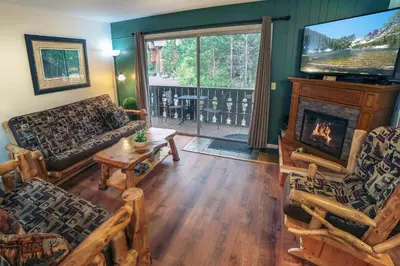 a living room with a couch and a fireplace at Fawn Valley Inn- 205 condo in Estes Park