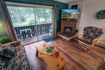 a living room with a couch and a table at Fawn Valley Inn- 205 condo in Estes Park