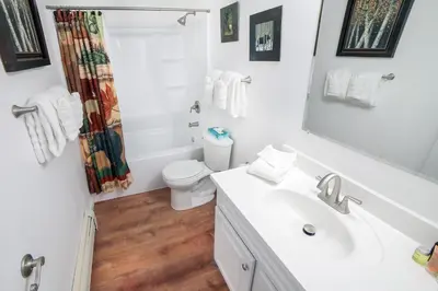 a white bathroom with a sink and a toilet at Fawn Valley Inn- 205 condo in Estes Park