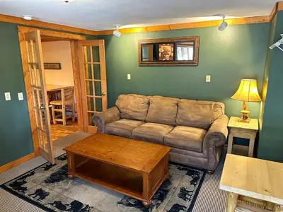 a living room with a couch and a coffee table at Timber Creek Chalets- 10B chalet in Estes Park