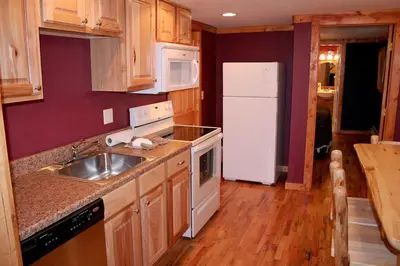 a kitchen with a sink and a white refrigerator at Timber Creek Chalets- 10B chalet in Estes Park