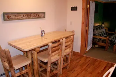 a wooden table and chairs in a room at Timber Creek Chalets- 10B chalet in Estes Park