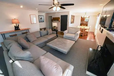 a living room with a couch and a flat screen tv at Fawn Valley Inn- 276 condo in Estes Park