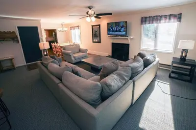 a living room with a large couch and a fireplace at Fawn Valley Inn- 276 condo in Estes Park