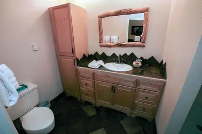 a bathroom with a sink and a mirror at Fawn Valley Inn- 276 condo in Estes Park