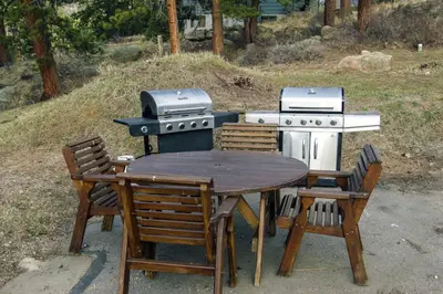 a table and chairs and a grill and a table with a table and a table at Fawn Valley Inn- 276 condo in Estes Park