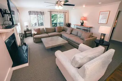 a living room with a couch and a tv at Fawn Valley Inn- 276 condo in Estes Park