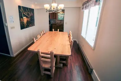 a dining room with a wooden table and chairs at Fawn Valley Inn- 276 condo in Estes Park