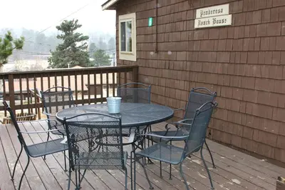a table and chairs sitting on a deck at Lazy R Cottages- 6 cabin in Estes Park