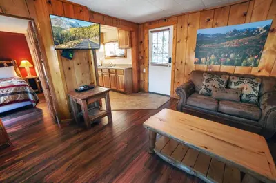 a living room with a couch and a table at Lazy R Cottages- 6 cabin in Estes Park