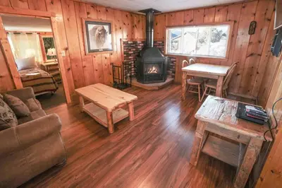 a living room with a couch and a fireplace at Lazy R Cottages- 6 cabin in Estes Park