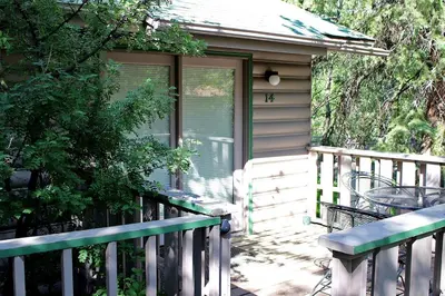a porch of a house with a door and a table at Sunnyside Knoll- 14 studio in Estes Park
