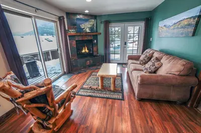 a living room with a couch and a fireplace at Lazy R Cottages- 16B cabin in Estes Park