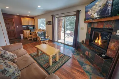 a living room with a fireplace and a couch at Lazy R Cottages- 16B cabin in Estes Park