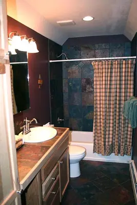 a bathroom with a sink and a toilet and a shower at Lazy R Cottages- 16B cabin in Estes Park